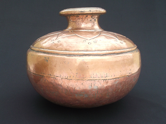 Antique copper water storage pot made out of 4 sections.