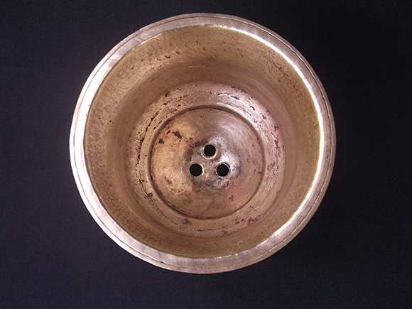 Sambrani pot with ventilating holes.