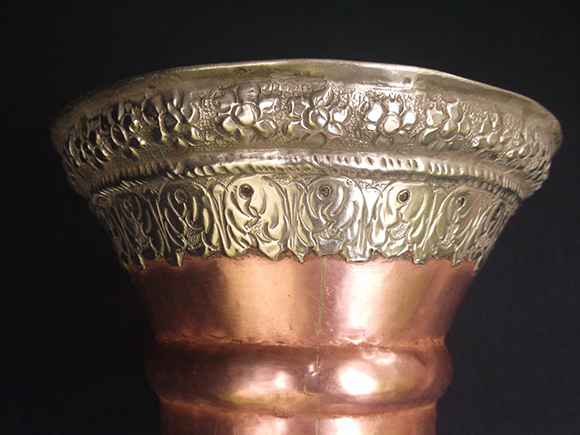 Buddhist Prayer  Trumpet -Close up view of the intricate design work on silver.