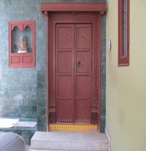 Full view of the door and the matching window seated with Ganesh idol