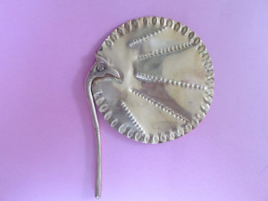 Antique hand-held fan showing a peacock holding the fan with its beak
