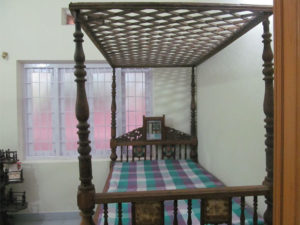 Four poster antique cot with mirror at the headboard and canopy on the 4 posts