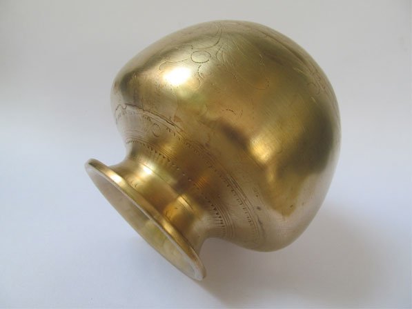 The picture showing the design on the antique fire walking brass pot. 