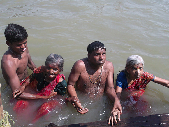 Emotional ecstasy of pilgrims after entering Sangam waters.