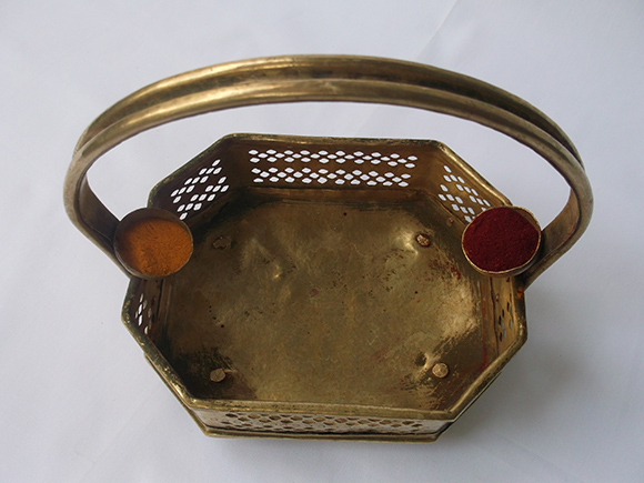 Two Small Bowls Riveted to the Handle Filled with Pasupu and Kumkum