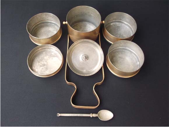 Tiffin carrier shown in dismantled condition-five dabbas, top lid, frame and spoon