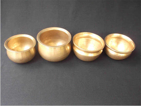 Antique Brass and Bronze curry pots in a row