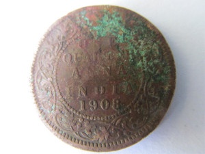 Year 1908 copper coin with multi-colour toning