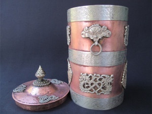 The cylindrical shaped Mystical copper vessel and the lid shown separately