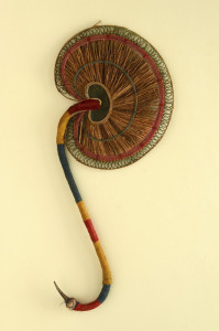 A hand-held fan made out of fragrant roots called VattiVeru resembling the design of the antique brass hand-held fan