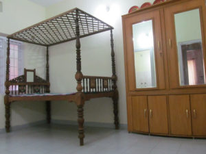 Mix of antique four post canopy cot with new wardrobe with mirrors
