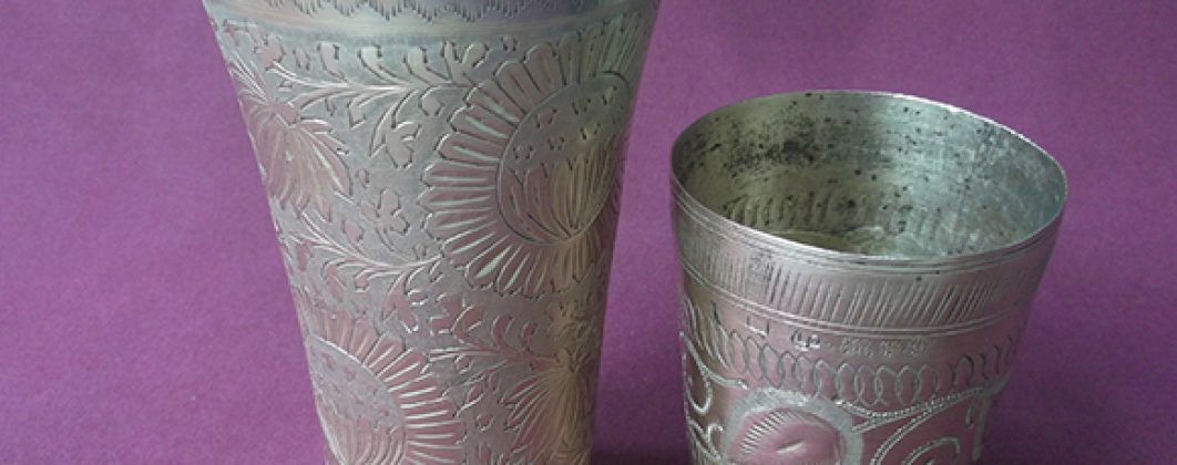 Large and small brass lassi glasses shown together.